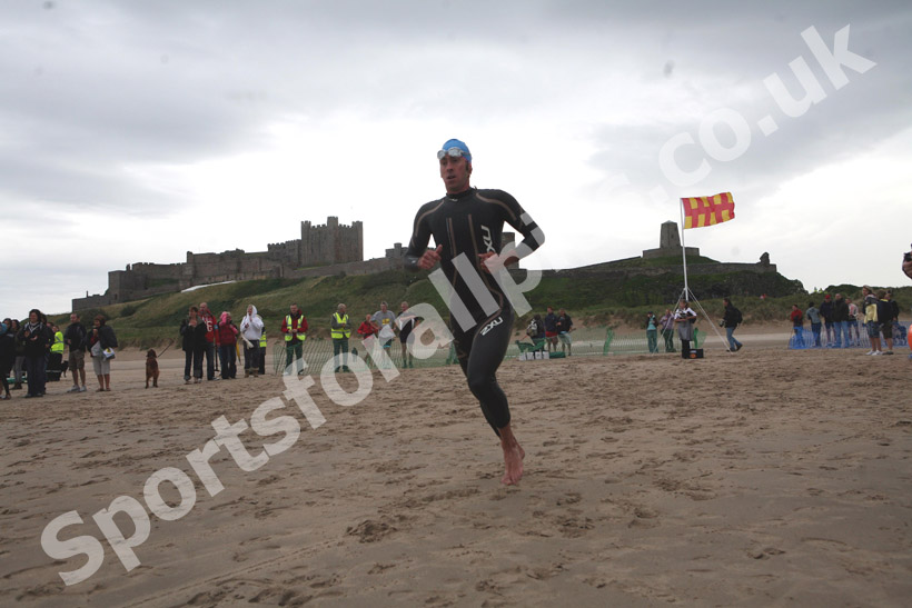 Start of the second lap in the simming during the Bamburgh Triathlon with Bamburgh Castle in the background
